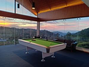 a pool table in a room with a view at Hilldale Retreat in Nuwara Eliya