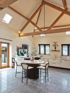a kitchen with a table and chairs in a room at Whytings Stud Barn 1 in Horsham