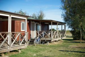 a cabin with a bike parked in front of it at Camping Village Capalonga in Bibione