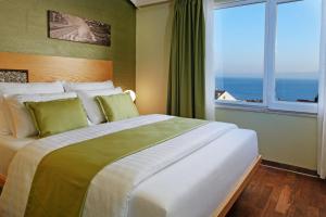 a bedroom with a large bed with a large window at Boutique Hotel Bol in Bol