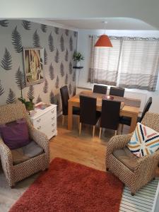 a dining room with a table and chairs at Brans Estate in West Mersea