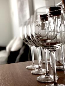 a row of wine glasses sitting on a table at City Home Finland Tampella - City View, Own SAUNA, One Bedroom, Furnished Balcony and Great Location in Tampere