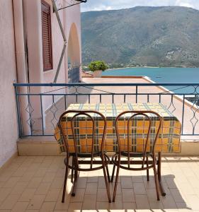 a table and two chairs sitting on a balcony at Panorama Plataria Ionio Studios&Apartments in Plataria
