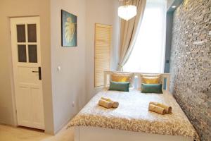 a bedroom with a bed with two pillows on it at Grey Rooms in Wrocław