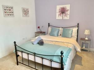 a bedroom with a bed and two night stands at Lahnstein Court in Kettering