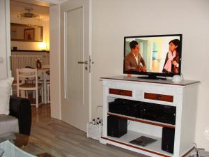 a flat screen tv sitting on top of a white entertainment center at Ferienwohnung am Nationalpark in Hellenthal