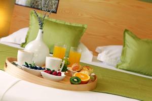 a tray of fruit and juice and drinks on a bed at Boutique Hotel Bol in Bol
