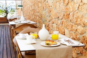 a table with a plate of food on it at Boutique Hotel Bol in Bol