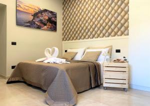 Un pat sau paturi într-o cameră la La Margherita Apartment