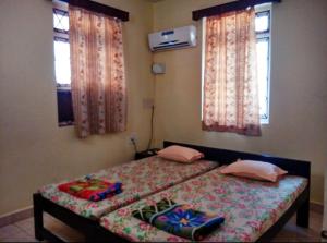 מיטה או מיטות בחדר ב-Bijou Guest House