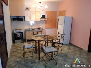 a kitchen with a table and chairs and a refrigerator at Casa San Román in La Rioja