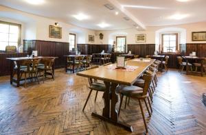 a dining room with wooden tables and chairs at Restaurace a penzion Stará pošta in Bečov nad Teplou