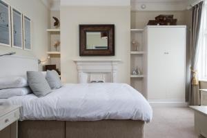 a bedroom with a bed with a mirror on the wall at The Marine in Whitstable
