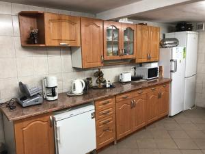 a kitchen with wooden cabinets and a white refrigerator at Agroturystyka Siołki in Siodłkowice