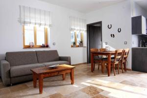 a living room with a couch and a table at Bernhardhof Andechs in Andechs