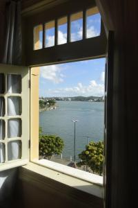 a window with a view of a body of water at Ilhéus Hotel in Ilhéus
