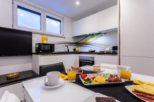 a kitchen with two plates of food on a table at Villa Valis in Baška