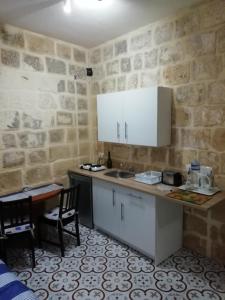 a kitchen with a counter and a sink and a table at Sixty Two 3 in Victoria