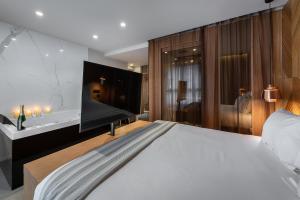 a bedroom with a large bed and a sink at 9Hotel Paquis in Geneva