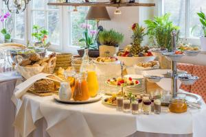 a buffet of food on a white table with food at Der Fischländer Garni in Ahrenshoop