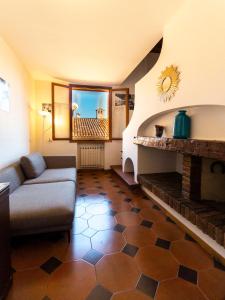 a living room with a couch and a fireplace at Residenza Ariosto Depandance by Studio Vita in Bologna