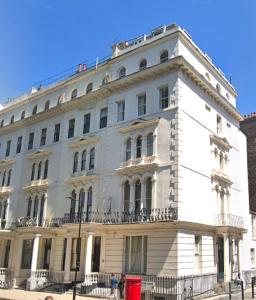 a large white building on a city street at London Collection - Bayswater in London