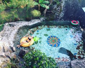 a woman laying on a raft in a swimming pool at Monte Mágico in Támesis +164 photos