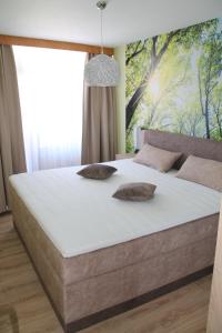 a bedroom with a large bed with two pillows on it at Apartment Schluchsee in Schluchsee