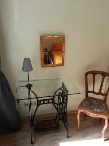 a glass table with a chair and a mirror at Bernkastler Graben in Bernkastel-Kues