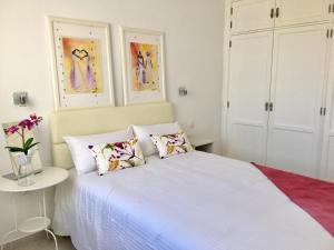 a bedroom with a white bed with two pillows at Apt BARLOVENTO. Near the beach in Tías +16 photos