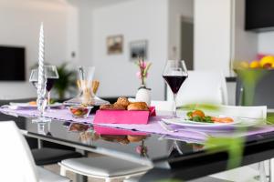 a table with plates of food and a glass of wine at Villa Valis in Baška