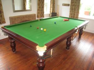 a pool table with balls on it in a room at Arden Hill Farmhouse - Hot Tub, Snooker Table, Sleeps 16 in Stratford-upon-Avon