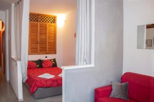 a small room with a red bed and a window at Vintage Apartment in Vernazza