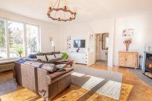 a living room with a couch and a tv at White Villa in Baden