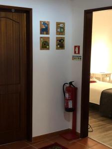 a room with a fire hydrant next to a bed at Apartamento - Casas dos Infantes in Caldas da Rainha +7 photos