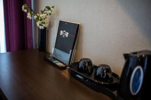 a laptop computer sitting on top of a wooden table at Royal Amsterdam Hotel in Amsterdam
