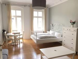 a bedroom with a bed and a table and chairs at Magnificent turn of century flat (legal) in Berlin