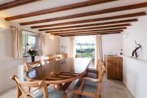 a dining room with a table and chairs at Camside, Chipping Campden - Taswell Retreats in Chipping Campden