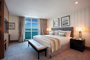a hotel room with a bed and a large window at Miramar By Windsor Copacabana in Rio de Janeiro