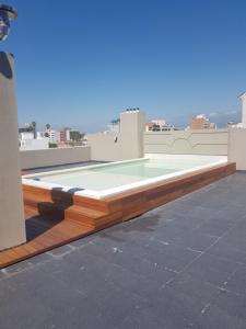 a swimming pool on the roof of a building at Leguizamon suite con cochera in Salta