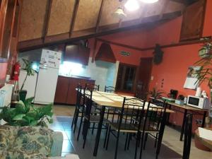a kitchen with a table and chairs in a room at Mirador del Beagle Hosteria in Ushuaia