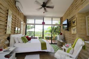 a bedroom with a bed and a ceiling fan at Hotel Casa Ambrosia in Villeta