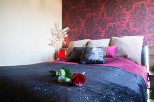a bedroom with a bed with two roses on it at Glamour in Budapest