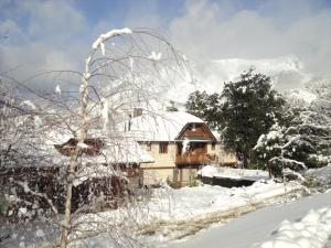 a house covered in snow in front at Arelauquen Bungalows & Suites in San Carlos de Bariloche +105 photos