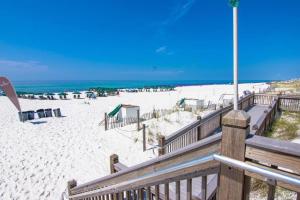 a view of the beach from a wooden boardwalk at Waterscape Resort by Tufan in Fort Walton Beach