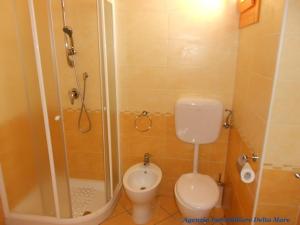 łazienka z prysznicem, toaletą i umywalką w obiekcie Apartment in Rosolina Mare 24935 w mieście Rosolina Mare