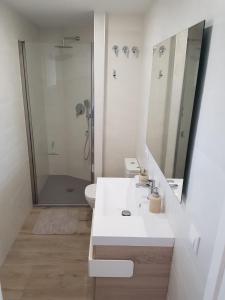 a white bathroom with a sink and a shower at BlancMar Apartament in Calpe +17 photos