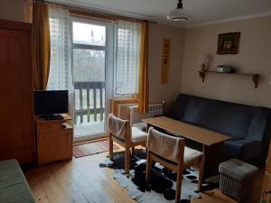 a living room with a table and a couch at Willa Marylka in Piwniczna