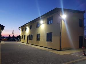 a building with a light on the side of it at Alda Gold in Pyrzowice