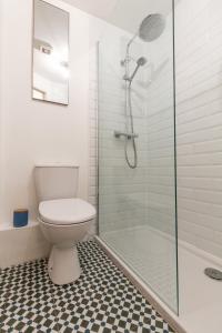 a bathroom with a toilet and a glass shower at PARK APARTMENTS at OBC in Belfast